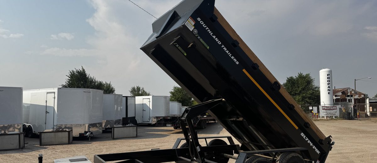 7x14 hydraulic dump trailer with the bed raised, showing the scissor hoist and barn doors